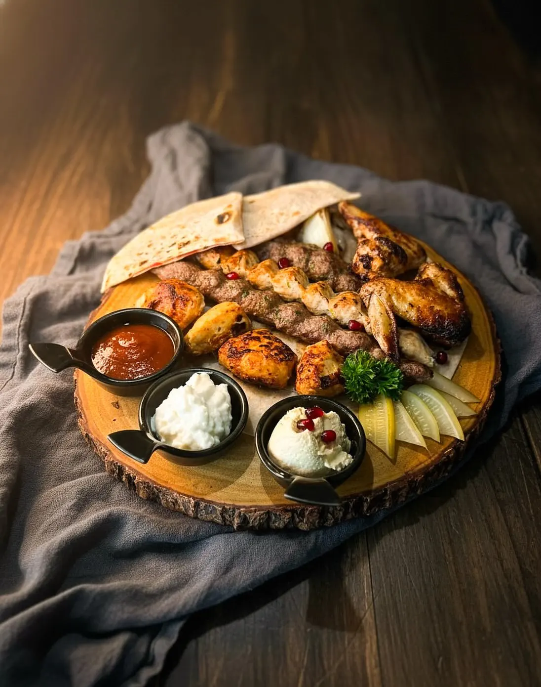Mixed BBQ plate from the grill with sauces and bread