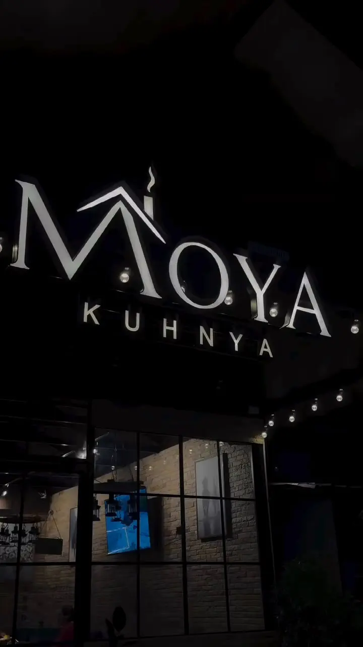 The Moya Kuhnya sign lit up at night